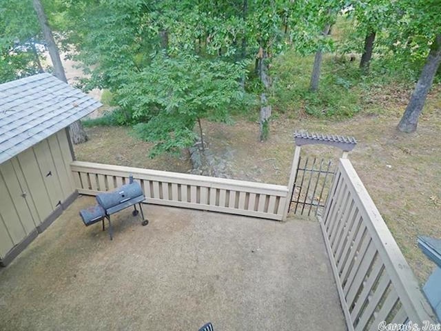 view of patio with an outdoor structure and a storage shed