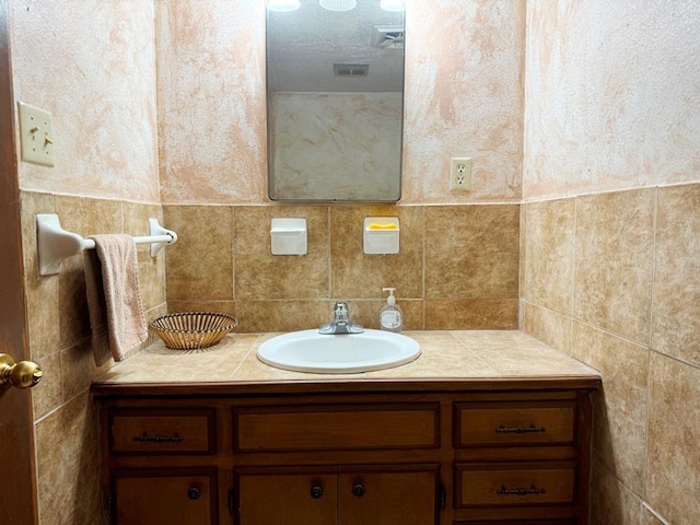 bathroom with tile walls, backsplash, and vanity