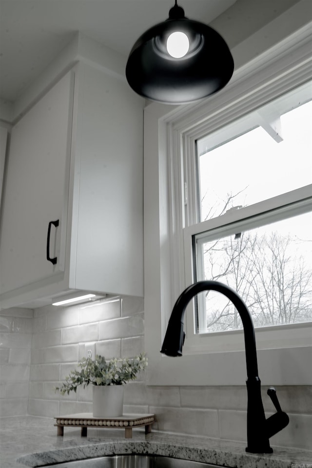 details with white cabinetry and decorative backsplash