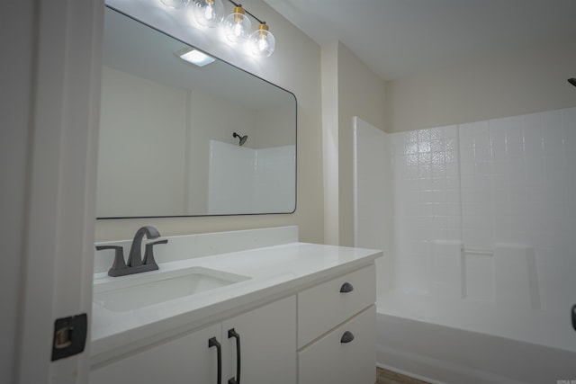 bathroom featuring  shower combination and vanity