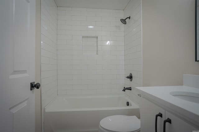 bathroom featuring washtub / shower combination, vanity, and toilet