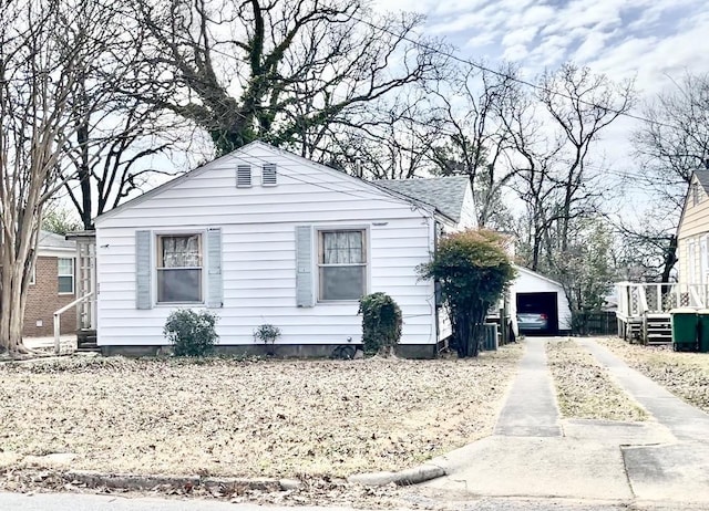 view of front of property featuring a garage and an outdoor structure