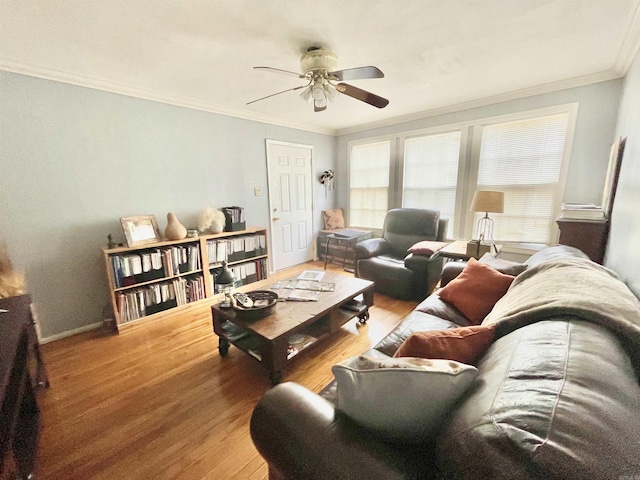 living room with ceiling fan, baseboards, crown molding, and wood finished floors