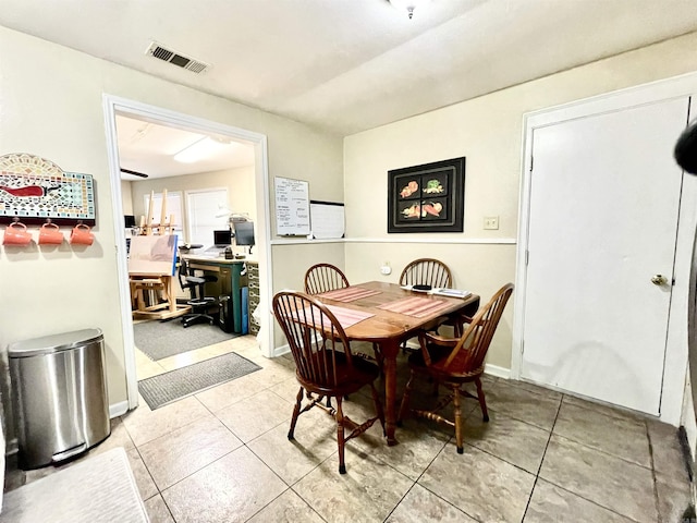 dining room featuring light tile patterned floors, visible vents, and baseboards