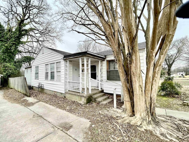 view of front of property featuring a shingled roof and a porch