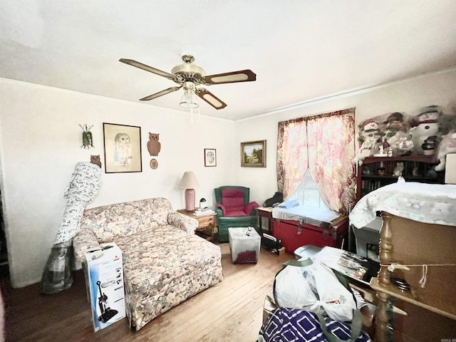 sitting room featuring ceiling fan and wood finished floors