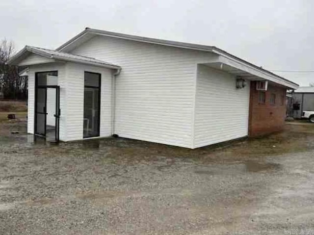 view of property exterior featuring a wall mounted air conditioner