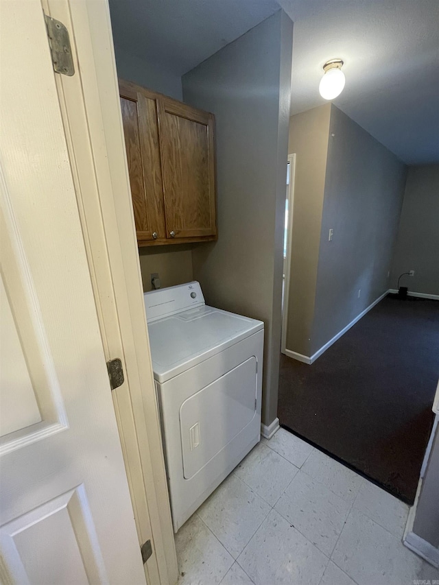 laundry area featuring washer / clothes dryer, cabinet space, and baseboards