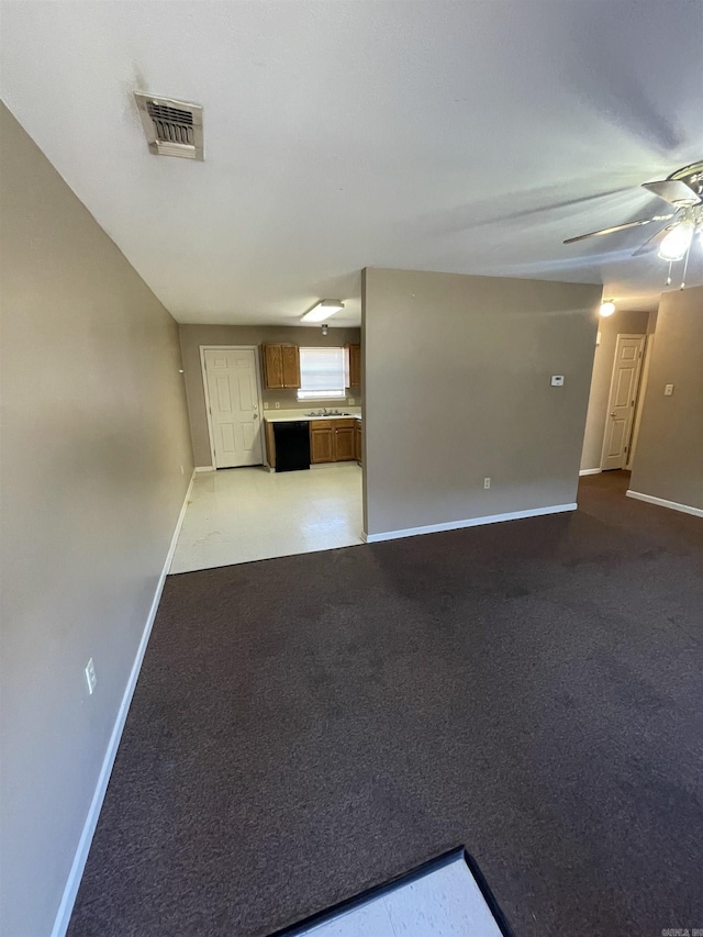 unfurnished living room with baseboards, visible vents, and light colored carpet