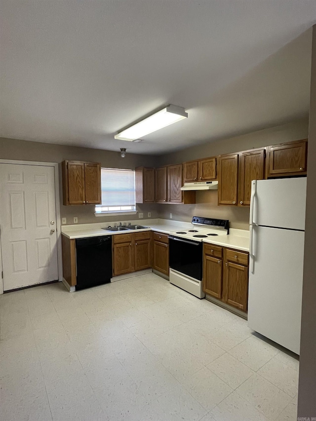 kitchen featuring white appliances, light countertops, under cabinet range hood, and light floors