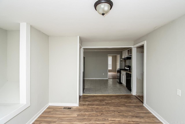 interior space featuring wood finished floors, visible vents, and baseboards