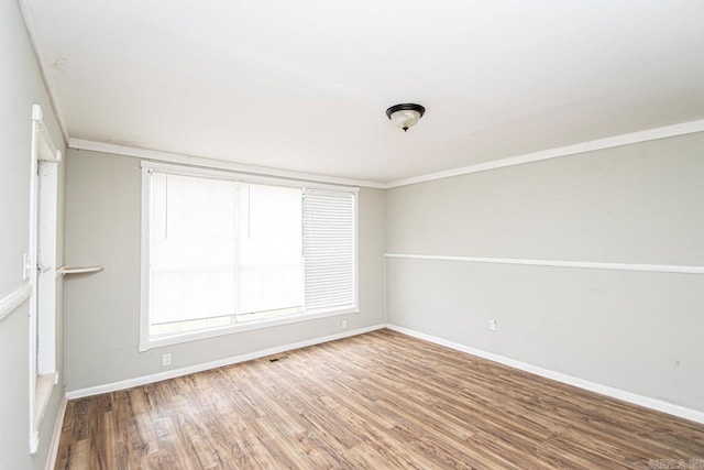 empty room featuring baseboards and wood finished floors