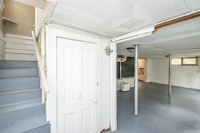 interior space featuring a textured ceiling and stairs