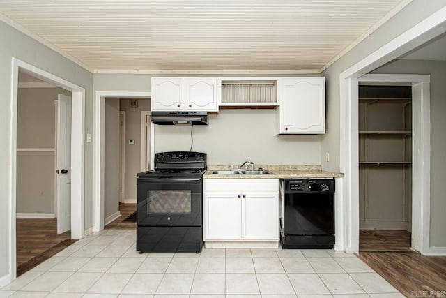 kitchen with black appliances, a sink, white cabinetry, and under cabinet range hood