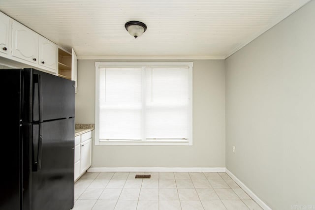 kitchen featuring visible vents, baseboards, freestanding refrigerator, white cabinetry, and open shelves