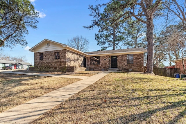 ranch-style home with brick siding, a front yard, and fence