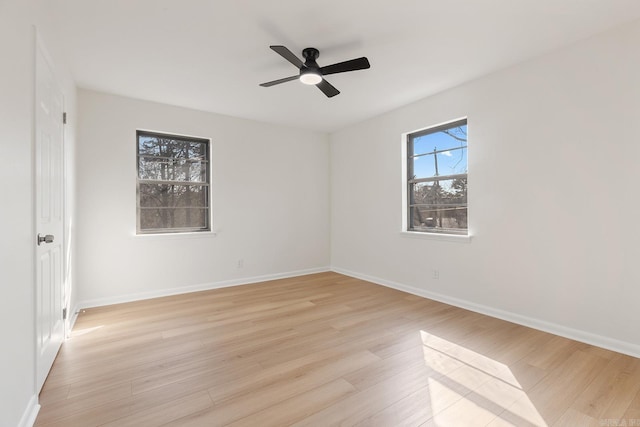 unfurnished room featuring light wood-style floors, ceiling fan, and baseboards