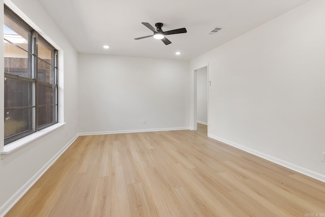 unfurnished room with recessed lighting, visible vents, light wood-style flooring, a ceiling fan, and baseboards