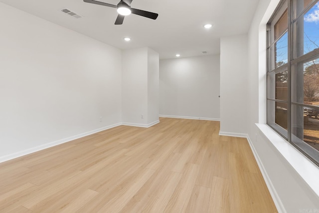 spare room featuring recessed lighting, visible vents, a ceiling fan, light wood-type flooring, and baseboards