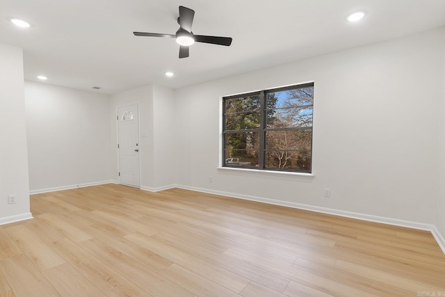 empty room featuring a ceiling fan, recessed lighting, light wood-style flooring, and baseboards