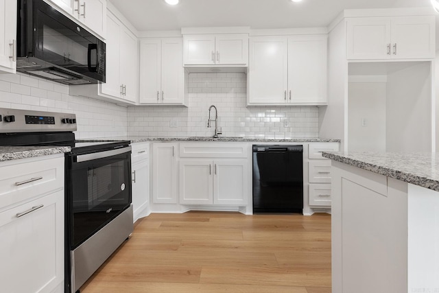 kitchen featuring black appliances, a sink, light wood-style flooring, and white cabinets