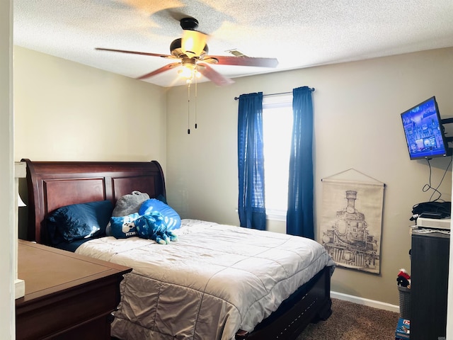 bedroom featuring a ceiling fan, carpet, a textured ceiling, and baseboards