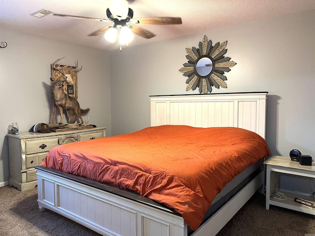 bedroom featuring carpet, visible vents, ceiling fan, and a textured ceiling