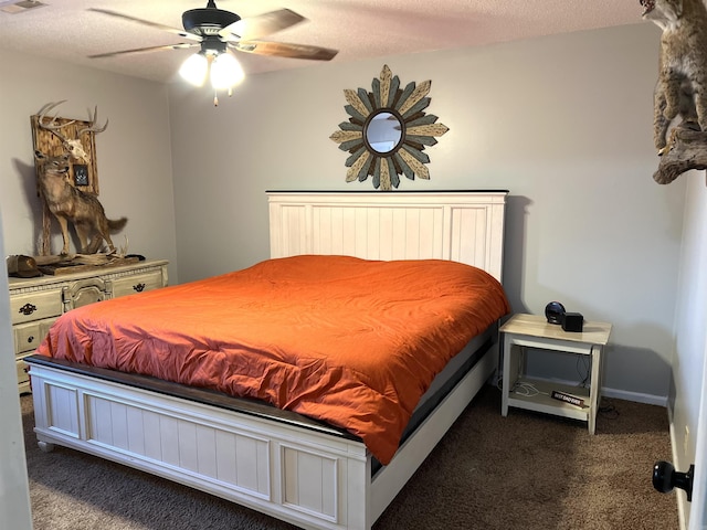 bedroom with visible vents, baseboards, ceiling fan, dark colored carpet, and a textured ceiling