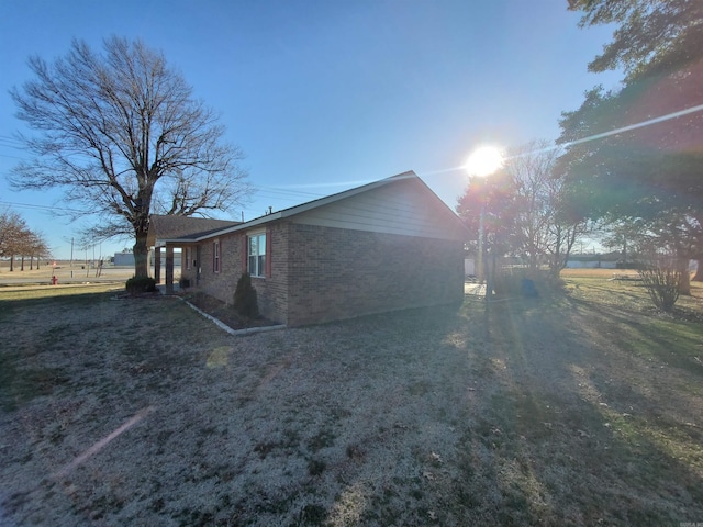 view of side of home with brick siding