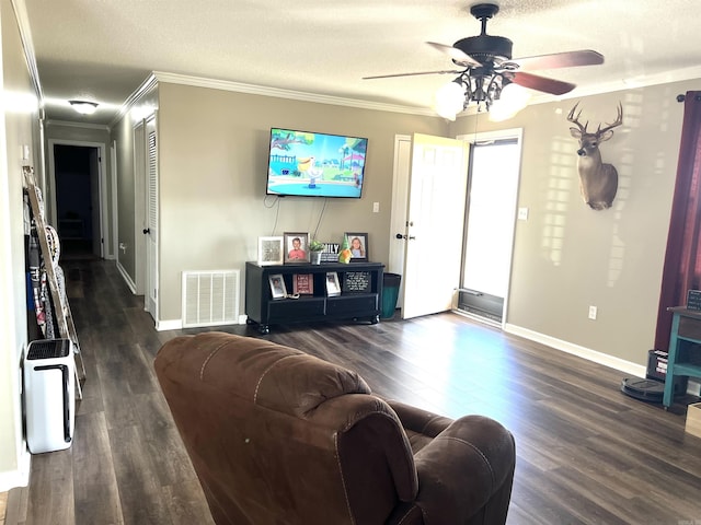 living room with visible vents, wood finished floors, and ornamental molding