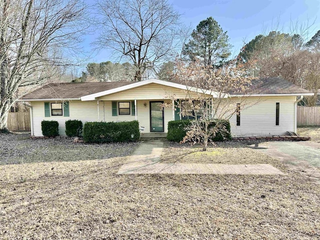 single story home featuring fence