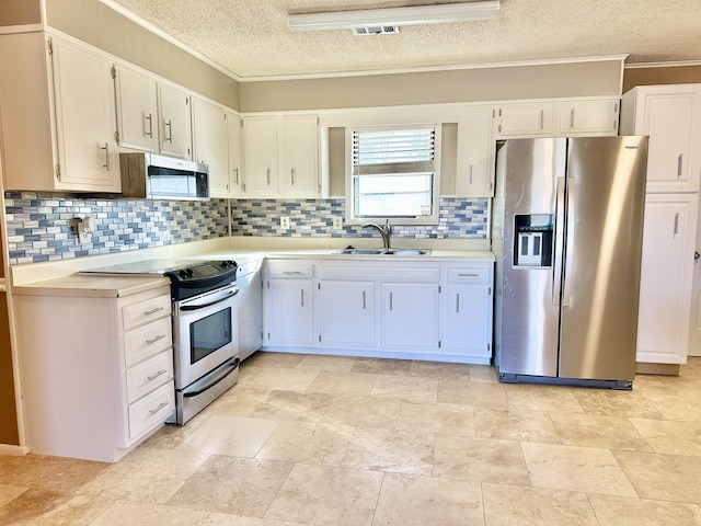 kitchen with stainless steel appliances, light countertops, visible vents, backsplash, and a sink