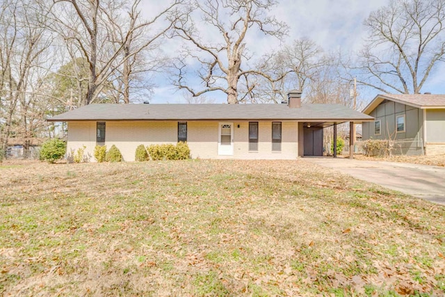 single story home with brick siding, a chimney, a carport, driveway, and a front lawn