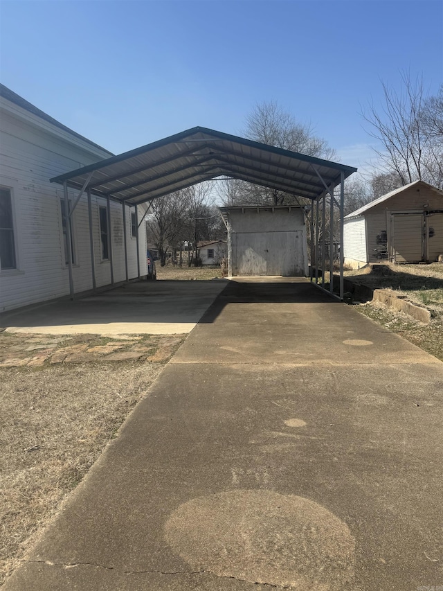 view of car parking with driveway and a detached carport