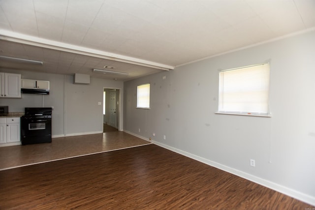 unfurnished living room with baseboards and dark wood-type flooring