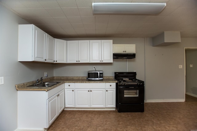 kitchen featuring stainless steel microwave, black gas range, white cabinets, a sink, and under cabinet range hood