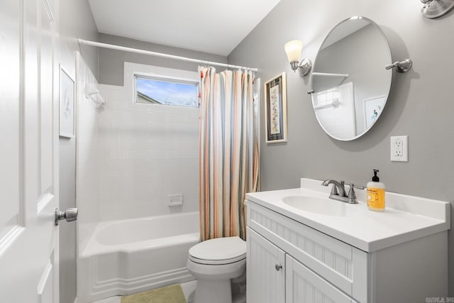 bathroom featuring vanity, shower / bath combo with shower curtain, and toilet