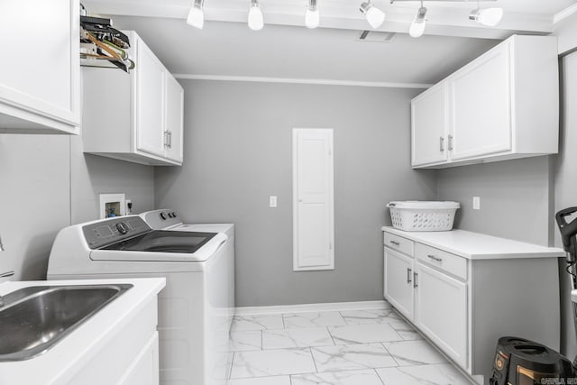 clothes washing area featuring washing machine and dryer, baseboards, marble finish floor, ornamental molding, and cabinet space