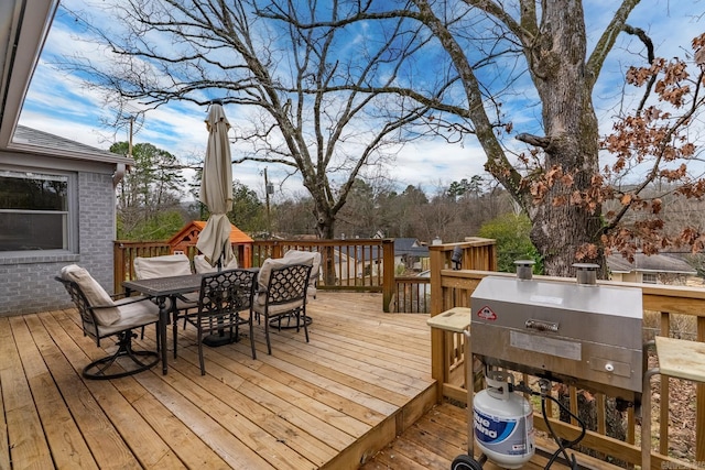 wooden deck featuring outdoor dining space