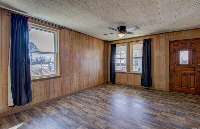 1612 Ridge Rd, El Paso, AR 72045 - interior space featuring baseboards, wooden walls, wood finished floors, and a healthy amount of sunlight