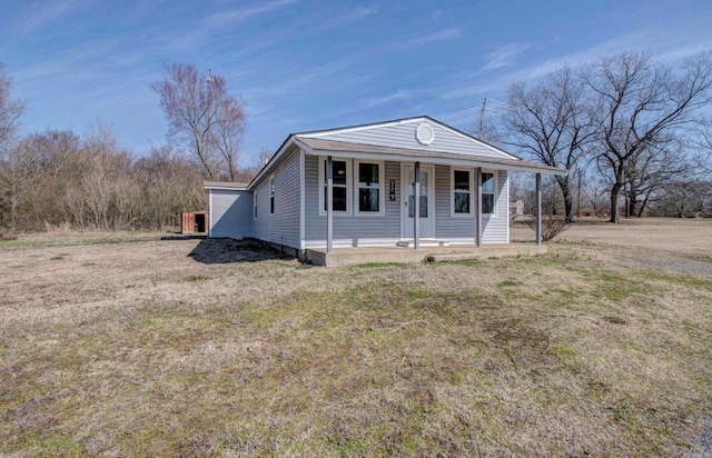 view of front of home with a porch and a front yard