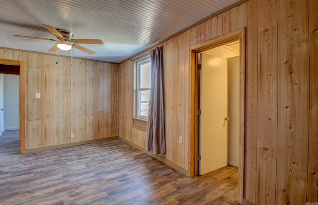 1612 Ridge Rd, El Paso, AR 72045 - unfurnished room with ceiling fan, wooden walls, baseboards, and wood finished floors