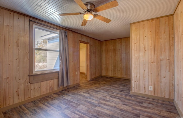 1612 Ridge Rd, El Paso, AR 72045 - empty room with ceiling fan, wood walls, wood finished floors, and baseboards