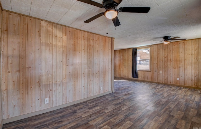 1612 Ridge Rd, El Paso, AR 72045 - spare room with wood walls, wood finished floors, and baseboards