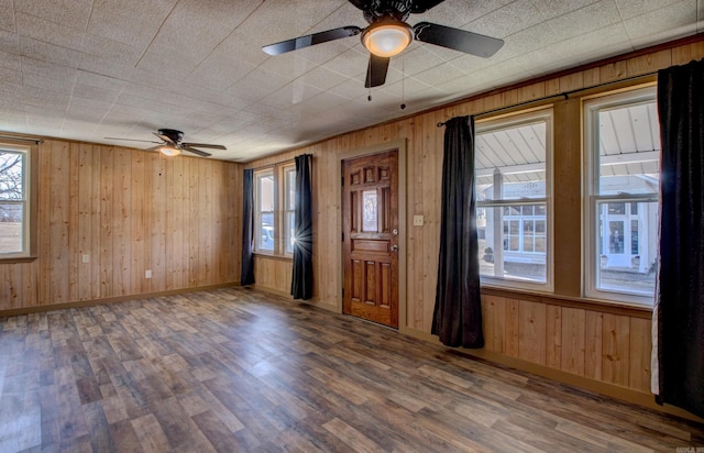 1612 Ridge Rd, El Paso, AR 72045 - entrance foyer featuring a ceiling fan, wooden walls, baseboards, and wood finished floors