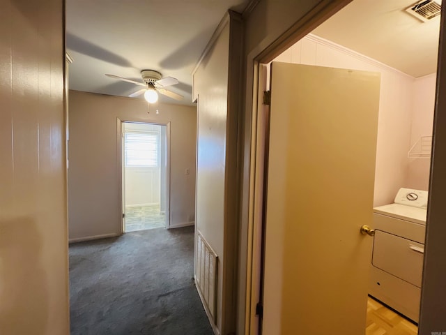 hallway featuring carpet, visible vents, and washer / clothes dryer