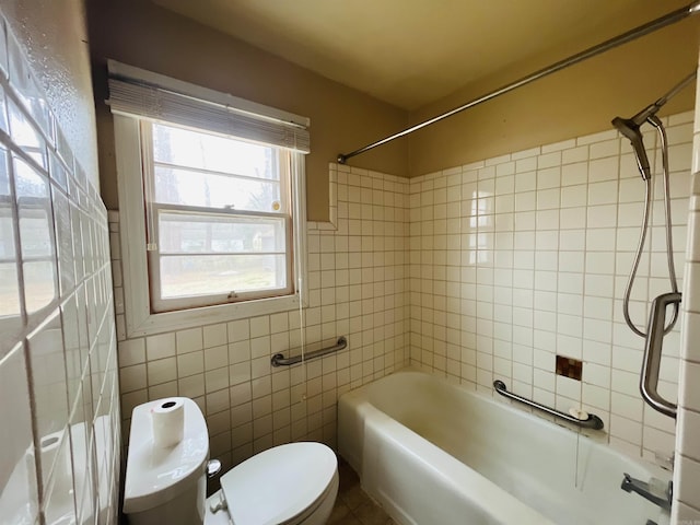 full bath featuring shower / bathing tub combination, toilet, and tile walls