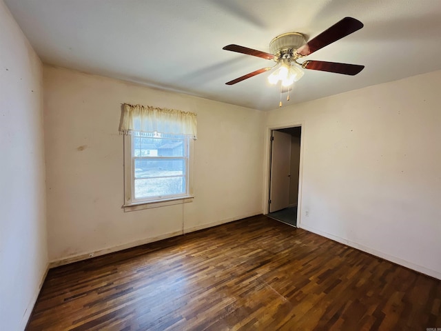 spare room with a ceiling fan, baseboards, and wood finished floors