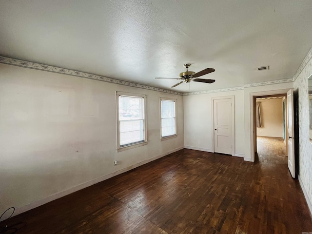 unfurnished room with dark wood-style floors, baseboards, and a ceiling fan