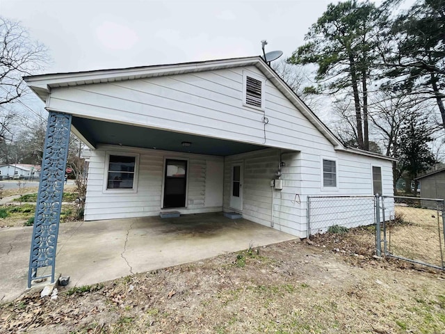 view of front of home featuring fence and an attached carport